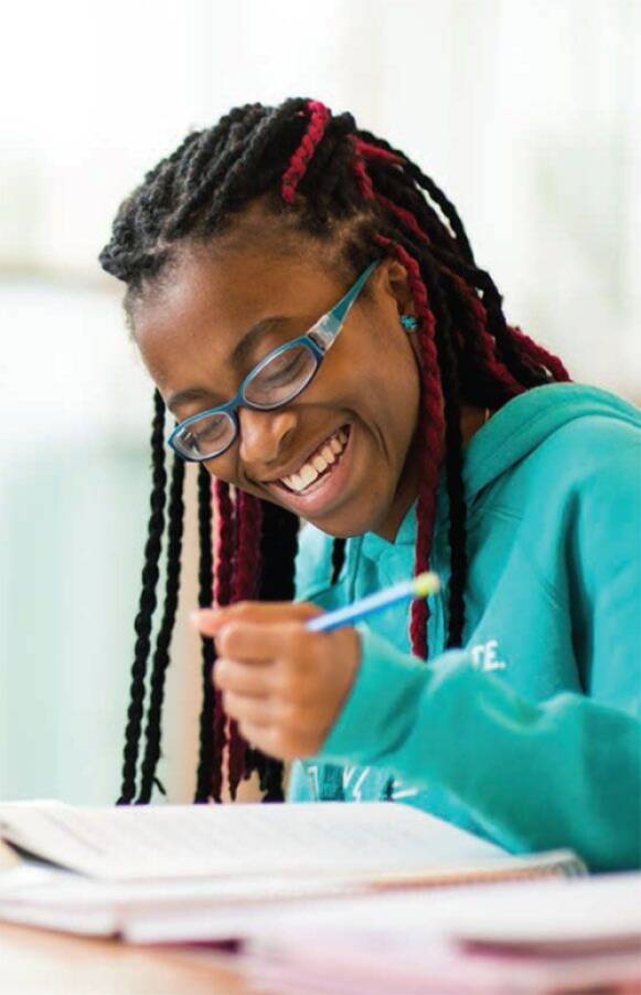 student writing in a notebook